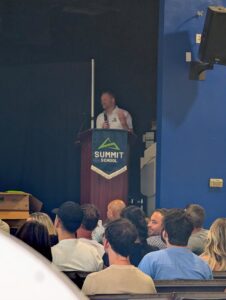 Kyle, Director of Admissions at Summit School, speaks at back-to-school night