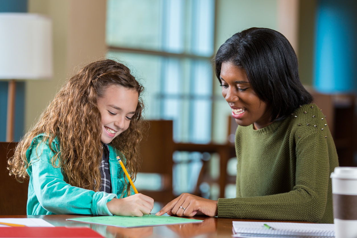 A Sugar Land tutor helps a student with her homework