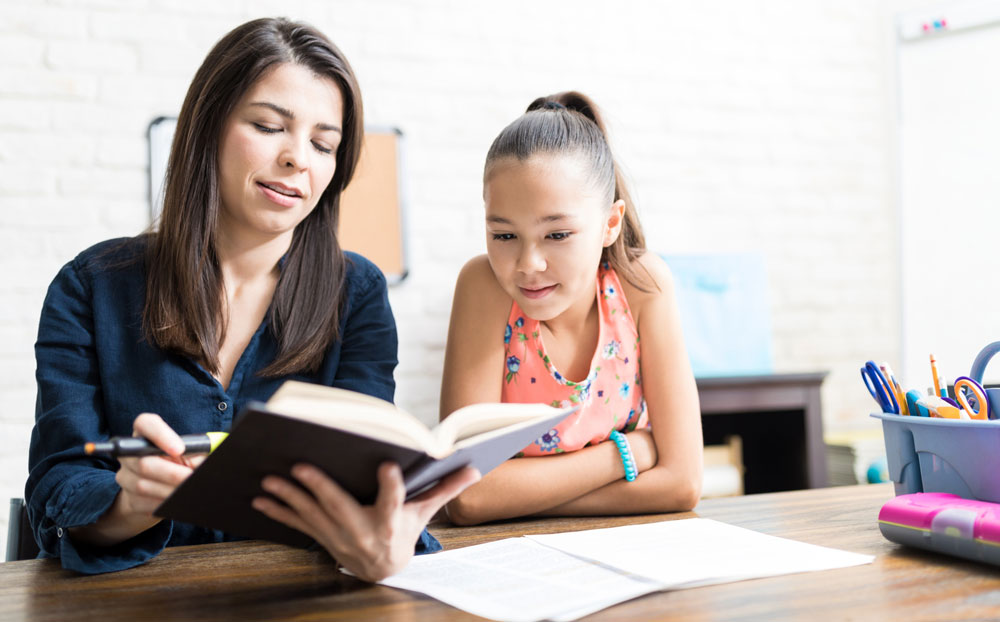 A Kelowna tutor helps a local student with their schoolwork