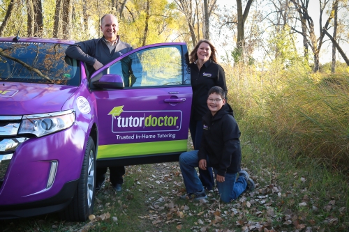 Rachel and Jeff Jensen with Son Posing with Tutor Doctor Car