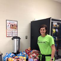 Employee Posing in front of Snacks