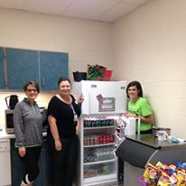 Three Employees Posing in front of Refrigerator