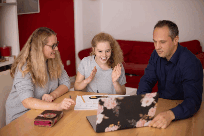 Middle Schooler with parents at the table studying