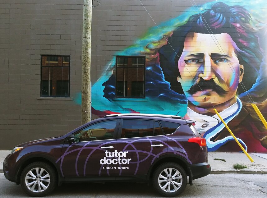 Tutor Doctor branded car infront of wall art