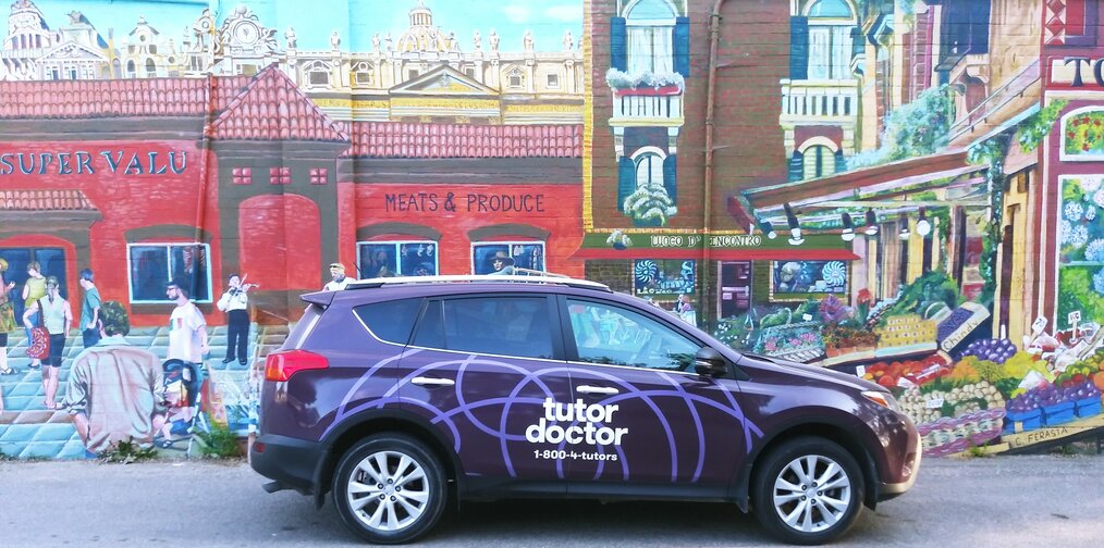 Tutor Doctor branded car infront of wall art