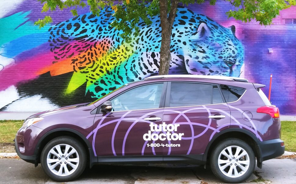 Tutor Doctor branded car infront of wall art