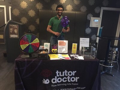 Man standing at Tutor Doctor event table