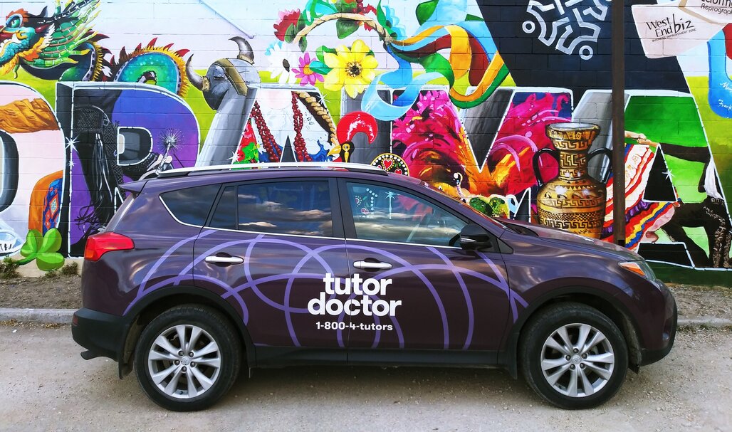 Tutor Doctor branded car infront of wall art