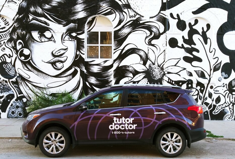 Tutor Doctor branded car infront of wall art