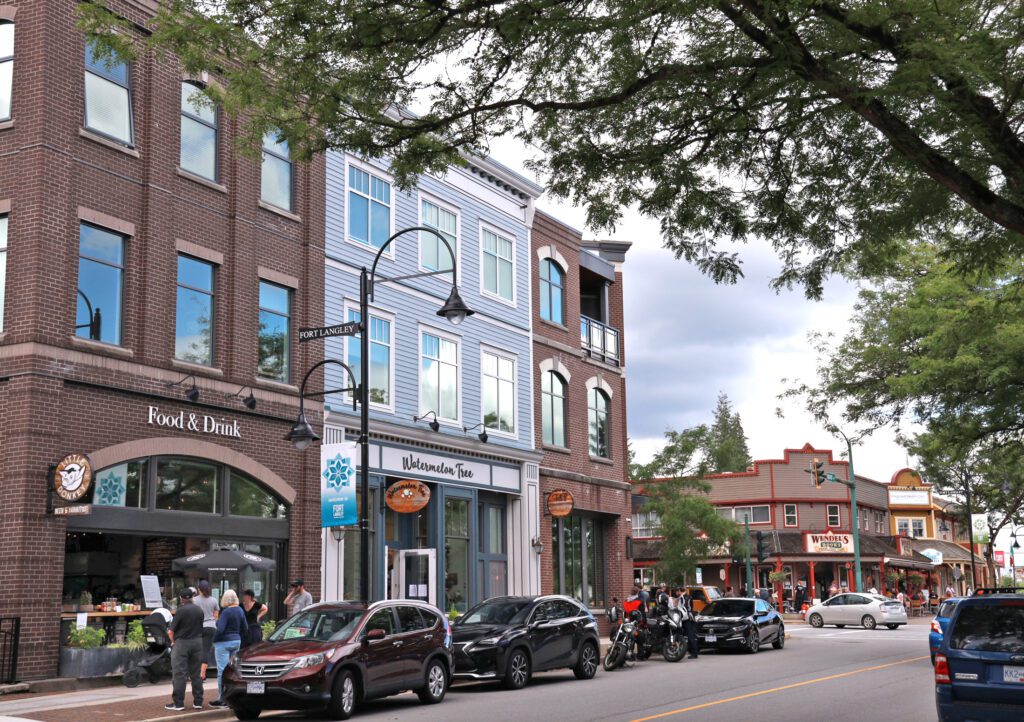 Langley, Canada - July 4, 2020: Popular businesses line Mavis Avenue in historic Fort Langley in Metro Vancouver. Residents and visitors stroll the tree-lined retail district in summer.