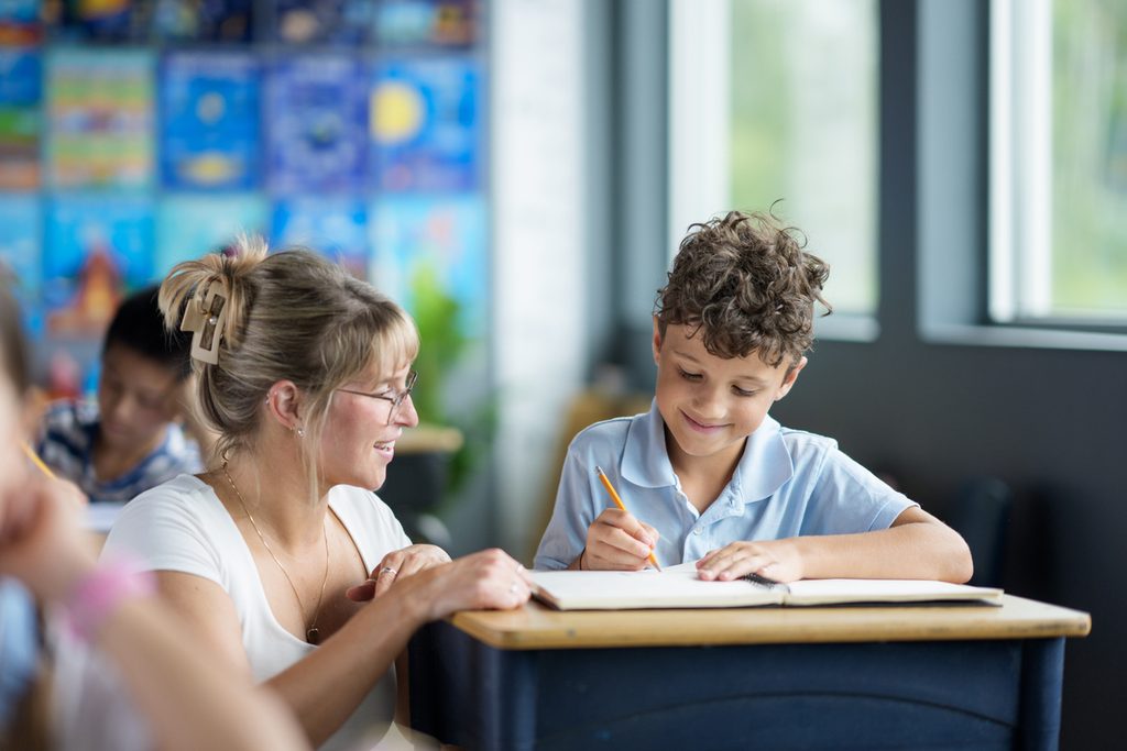 A tutor reading one-to-one with a student