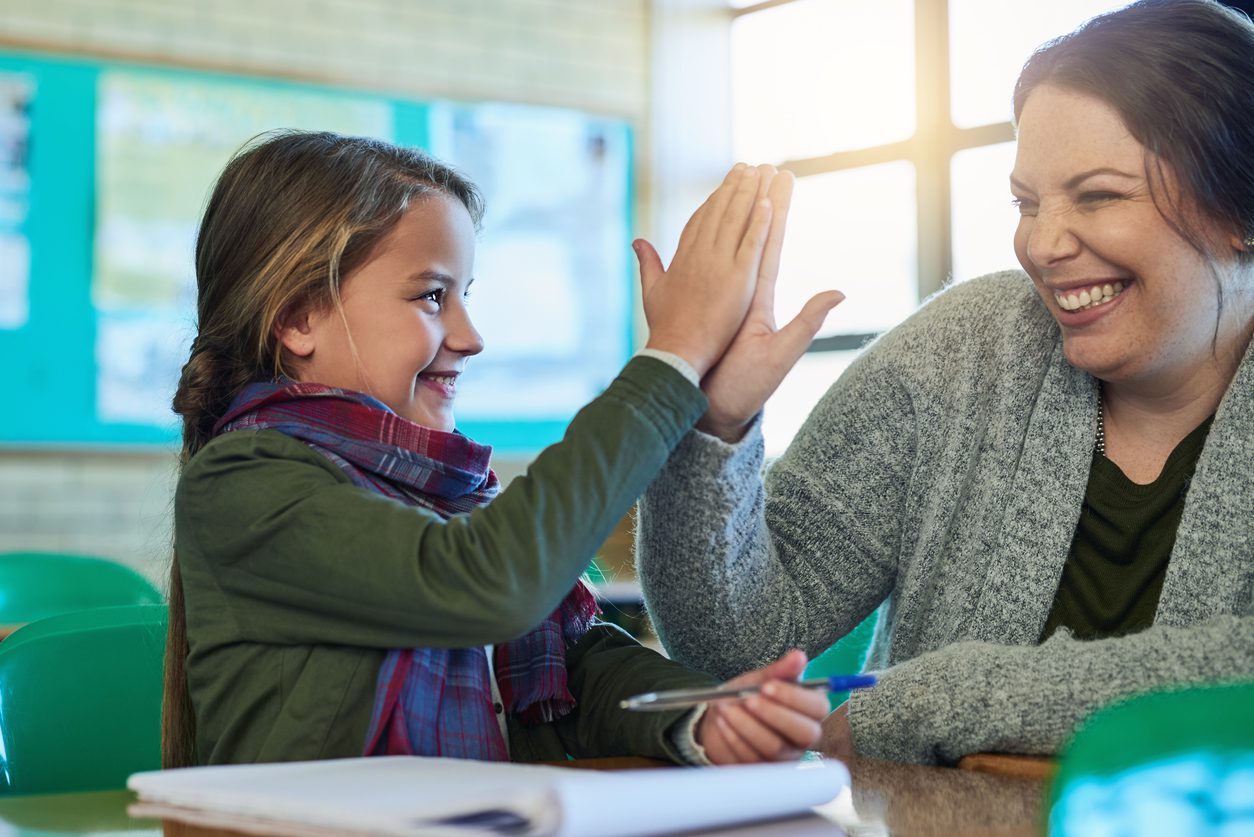 Student and tutor high fiving