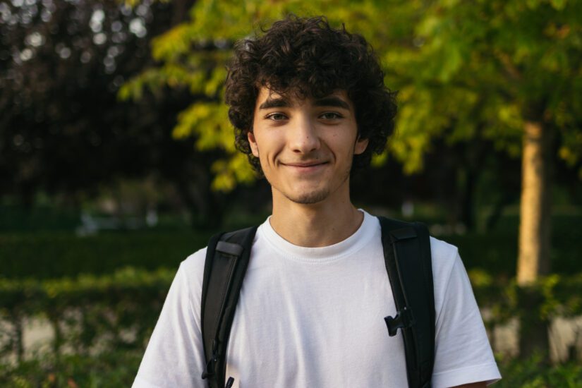 Smiling student outside in a park