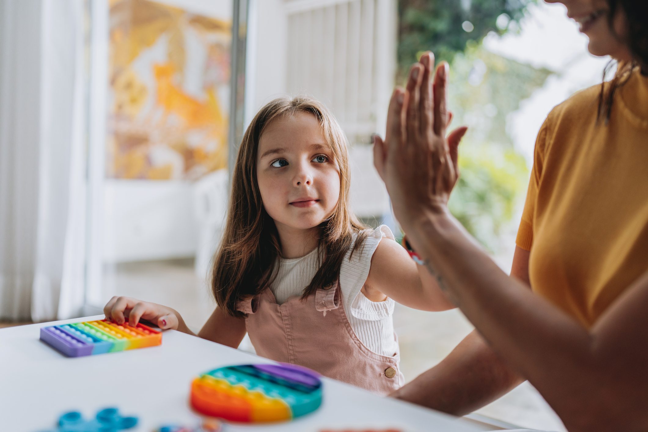 Child high fiving their tutor