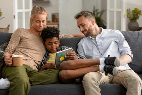 A happy family reviewing their child's work after help from a Tutor Doctor tutor.