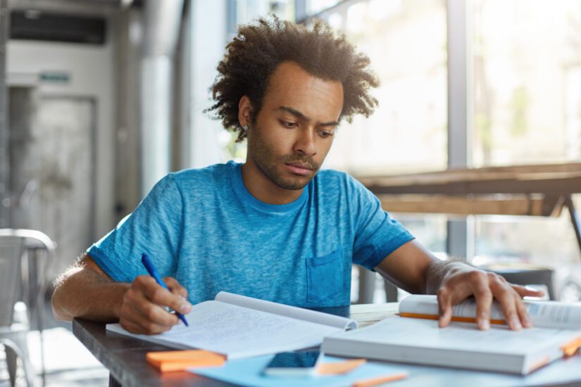 Student sits at desk and studies for SAT