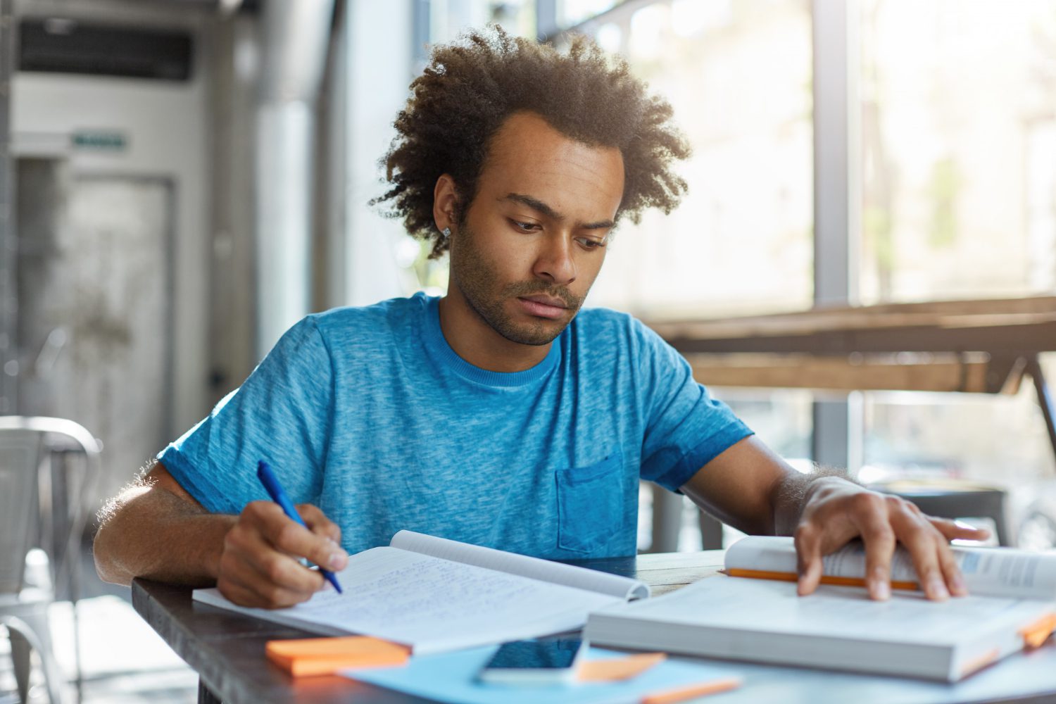 Student sits at desk and studies for SAT
