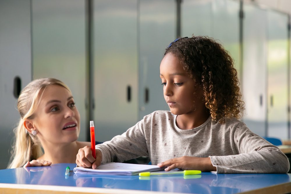Teacher helping her student with math
