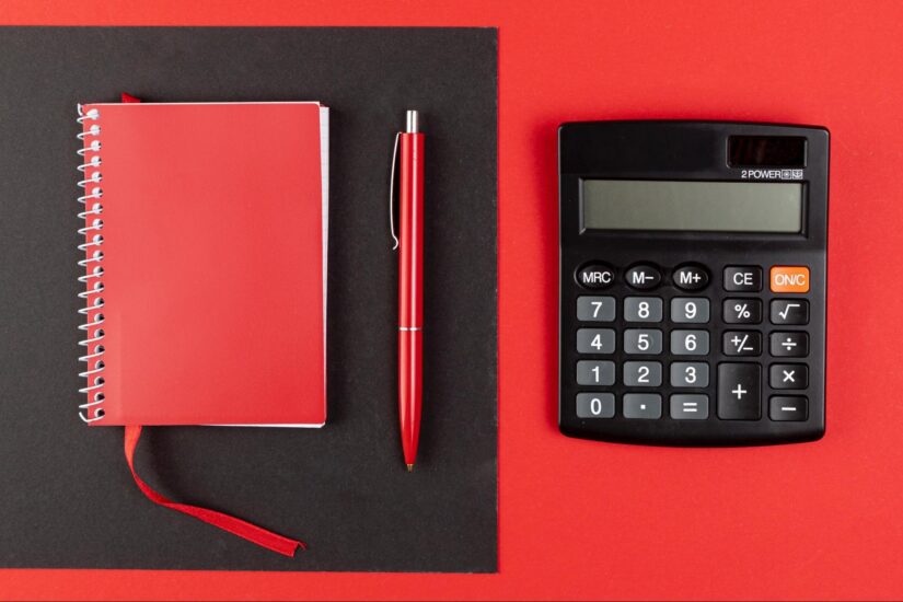 Notebook and calculator side by side on desk