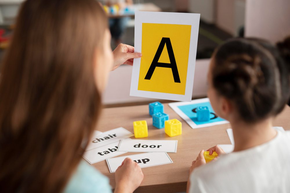 Student in classroom learns reading and phonics with flashcard